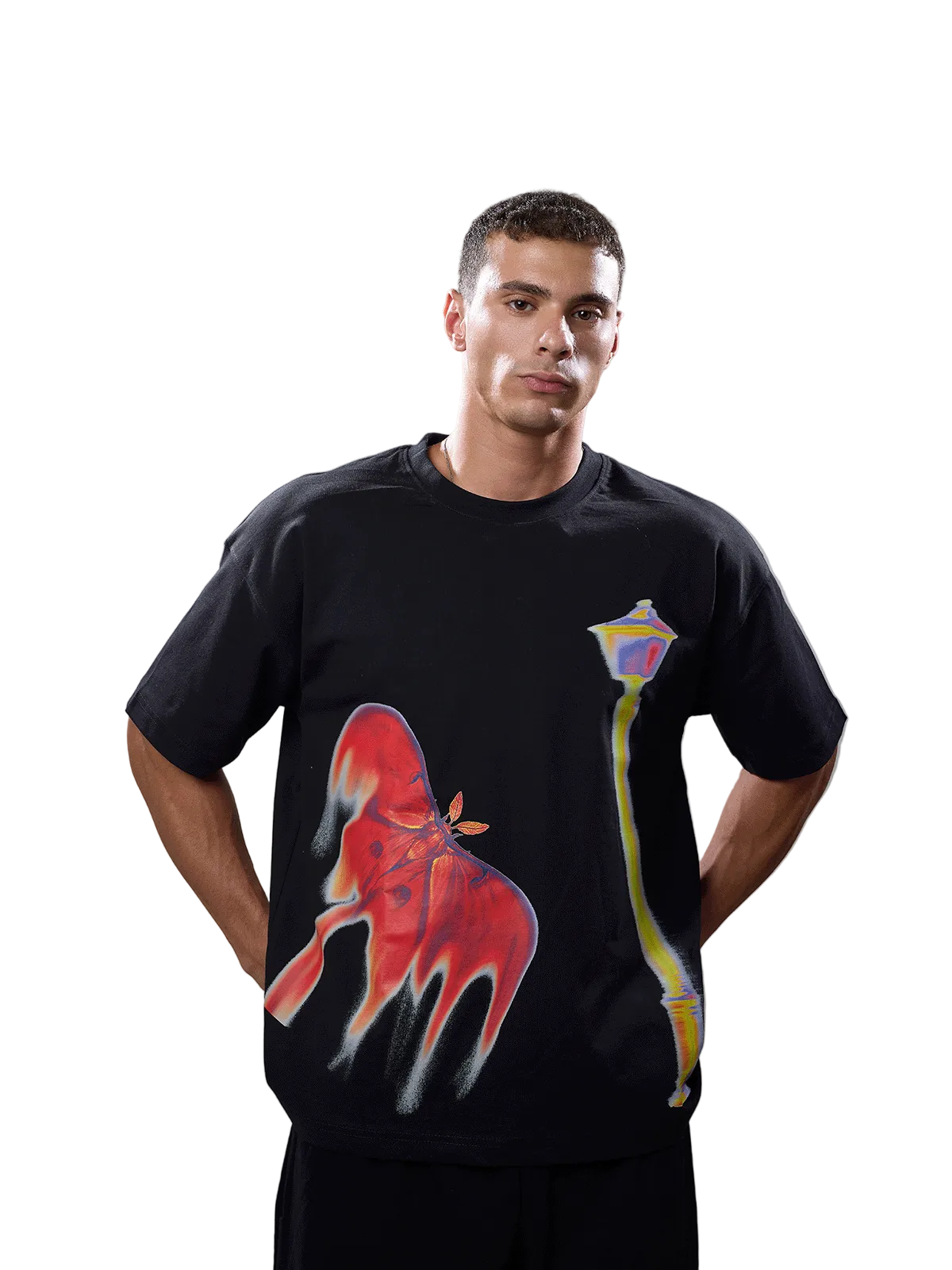 A man wearing a black short-sleeve t-shirt with a large red dripping graphic on the front and a yellow street lamp graphic, posed against a solid gray studio background.