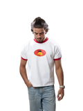 A man wearing a white ringer t-shirt with red trim and a red and yellow graphic on the chest, paired with light blue jeans, standing against a solid gray background.
